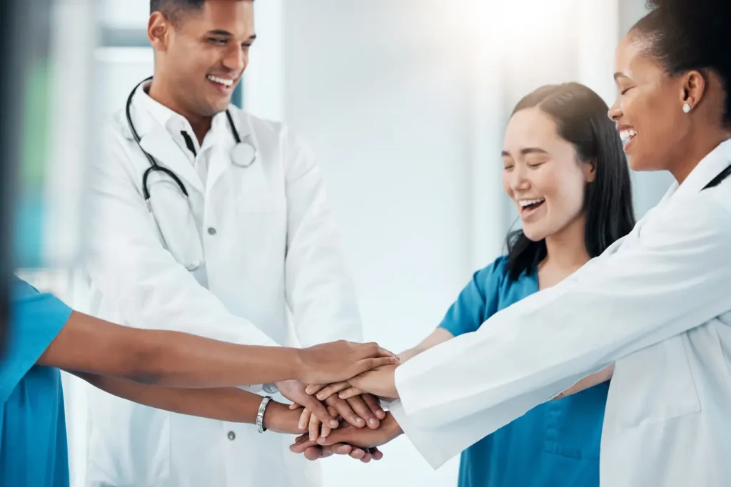 A medical team joining hands in support