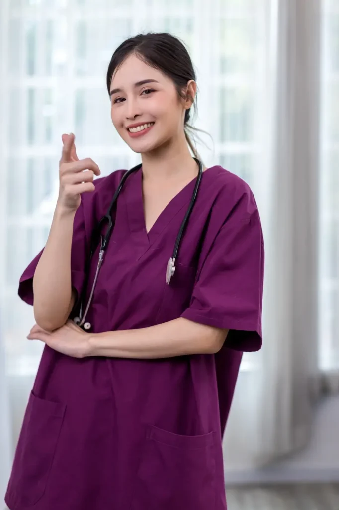 A healthcare worker in scrubs with a stethoscope